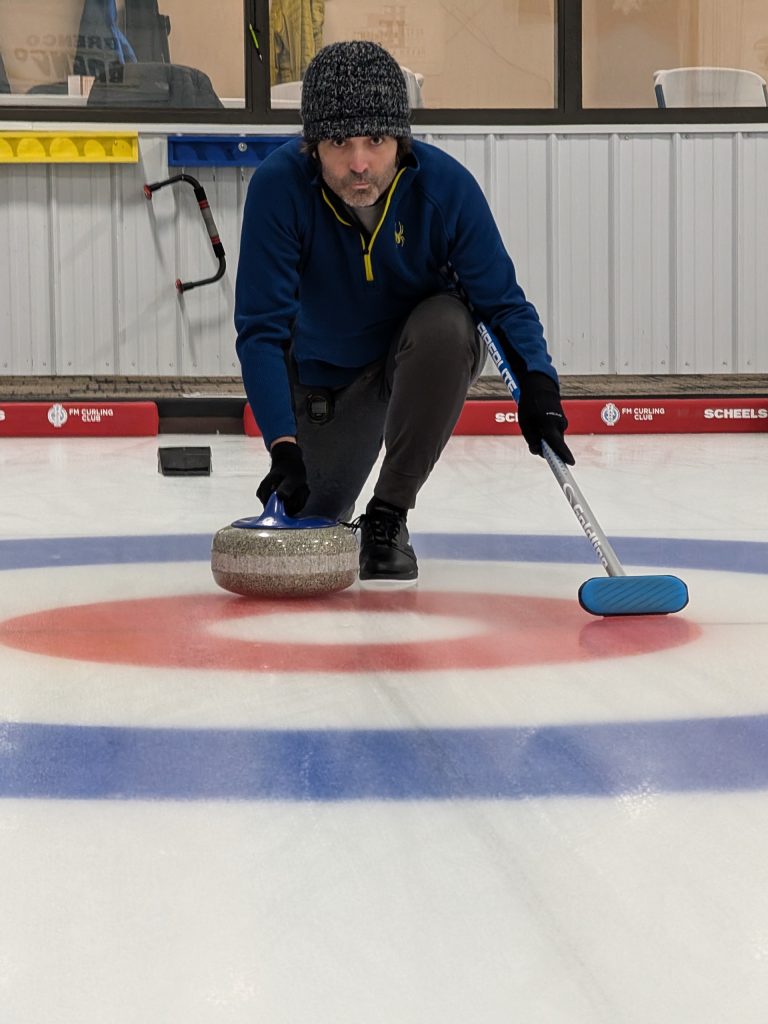 Tyler Sand playing curling